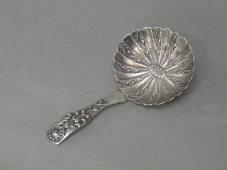 A George IV silver fiddle pattern caddy spoon with scallop shaped bowl, Birmingham 1822, by Samuel Pemberton   ILLUSTRATED