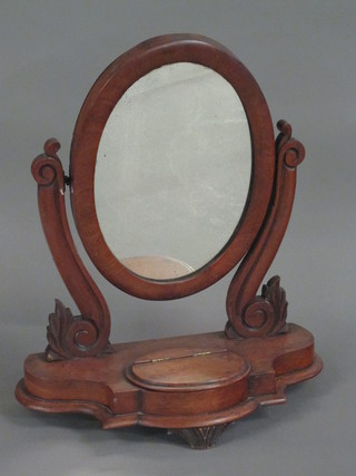 A Victorian oval plate dressing table mirror contained in a  mahogany swing frame, the base fitted a trinket box