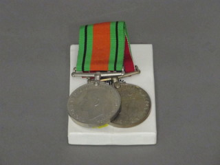 A pair of medals comprising Defence and War medal with cardboard box