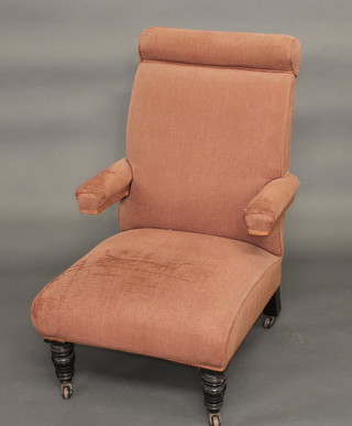 A Victorian mahogany armchair upholstered in pink material  raised on turned supports