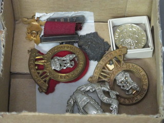 A WWII discharge badge, a Royal Tank Regt. cap badge, a  School Attendance medal and a small collection of other badges