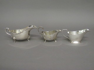 A heavy silver plated sauce boat with wavy border and 3 other sauce boats/jugs