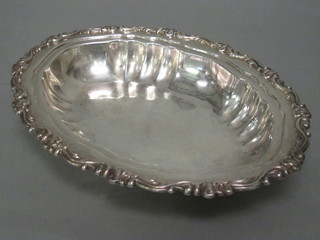 An oval white metal dish marked 925 13"