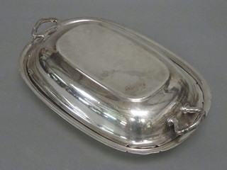 An oval twin handled silver plated entree dish and cover
