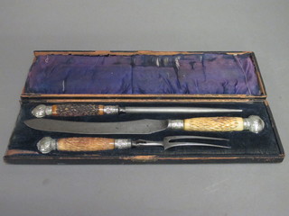 A Victorian steel 3 piece carving set with stag horn handles by George Butler & Co. cased,
