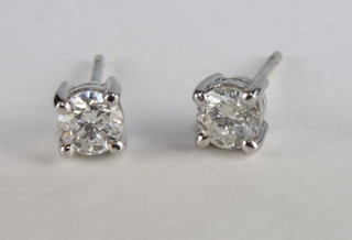 A pair of diamond claw set earrings, approx 0.58ct