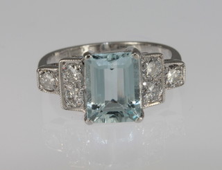 A lady's 18ct white gold dress ring set a rectangular cut aquamarine, the shoulders set 6 diamonds, approx 2.0/0.55ct