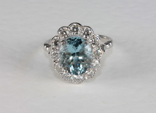 A lady's 18ct white gold dress ring set an oval cut aquamarine supported by diamonds, approx. 2.50/1.05ct