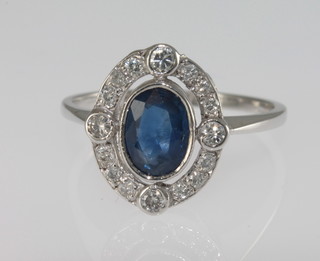 A lady's 18ct white gold dress ring set an oval cut aquamarine surrounded by diamond approx 1.40/0.60ct