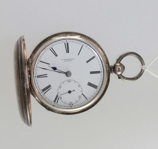 A pocket watch contained in a full hunter case by J Hendrick of  London contained in a silver case