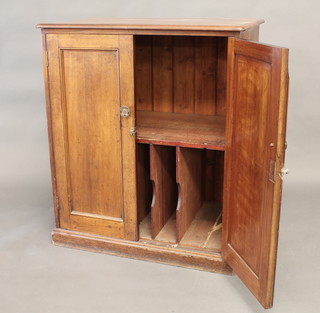 An Edwardian walnut cabinet, the shelved interior enclosed by panelled doors, raised on a platform base 36"