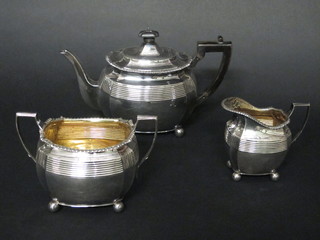A silver plated 3 piece tea service of oval reeded form with teapot, twin handled sugar bowl and milk jug