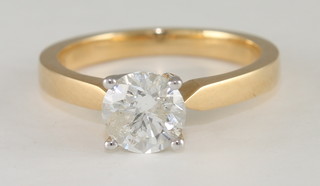 An 18ct yellow gold dress/engagement ring set a solitaire diamond, with certificate
