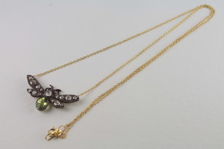 A pendant in the form of a bee set diamonds, peridot and ruby,  stone to eye missing,