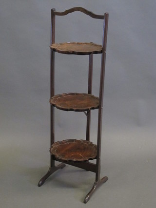 A Chippendale style mahogany 3 tier folding cake stand with bracketed border