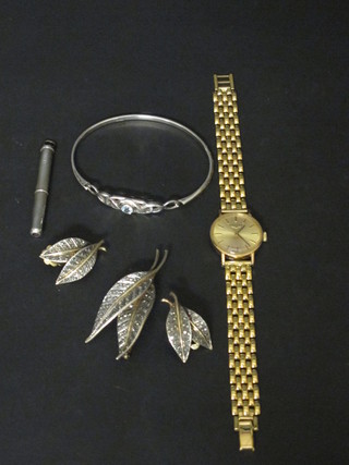 A silver cased toothpick, a silver bracelet, a marcasite brooch and  ear clips and a Lady's Longines wristwatch etc
