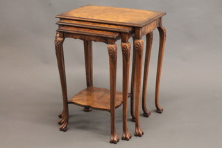 A nest of 3 rectangular figured walnut coffee tables, raised on cabriole supports 21"