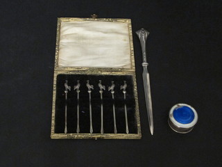 A set of 6 silver cocktail sticks, a silver and blue enamelled rouge  pot, lid f, and a silver paper knife
