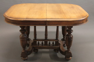 A Continental bleached oak extending dining table with 2 extra leaves, raised on turned supports 41"