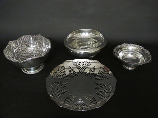 A silver plated bowl with swing handle raised on a spreading foot  6", a pierced silver plated pedestal bowl 10", a circular silver  plated fruit bowl on hoof feet 8" and a silver plated rose bowl 8"