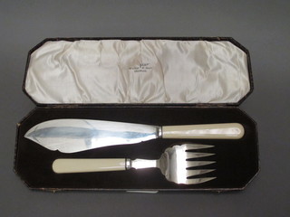 A pair of silver plated fish servers by Walker & Hall, cased