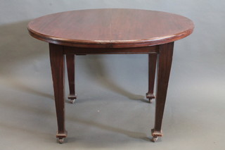 An Edwardian circular mahogany dining table, raised on square tapering supports 49"