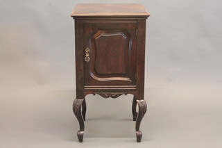 An Edwardian mahogany bedside cabinet enclosed by panelled  doors, raised on cabriole supports 18"