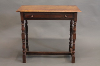 A carved oak side table fitted a frieze drawer, raised on turned  and block supports with H framed stretcher 33"