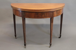 A Georgian mahogany inlaid satinwood stringing demi-lune tea table, raised on square tapering supports ending in spade feet 41"