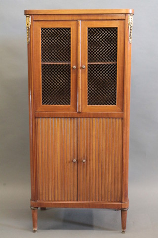 A 19th Century French D shaped cabinet the upper section  enclosed by grilled panelled doors, the base enclosed by panelled  doors, raised on panelled feet 24"