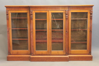 A Victorian walnut breakfront sideboard, the interior fitted adjustable shelves enclosed by glazed panelled doors, with fluted  columns, raised on a platform base 72"   ILLUSTRATED