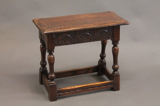 A rectangular carved oak joyned stool, raised on turned and  block supports 22"