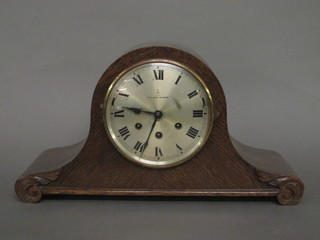A chiming mantel clock by Gustav Becker with silvered chapter  ring and Roman numerals, contained in an oak Admiral's hat  shaped case and retailed by Mappin & Webb