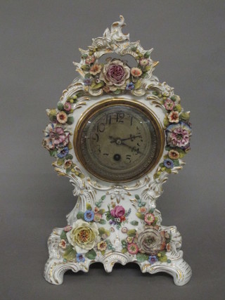 A 19th Century Continental mantel clock with silvered dial and Arabic numerals contained in a floral encrusted case