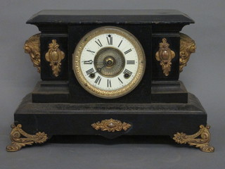 A 19th Century American striking mantel clock with enamelled  dial and Roman numerals, contained in an iron case
