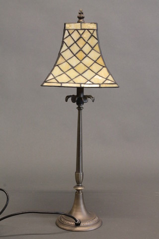 A metal table lamp with square flared lead glass shade