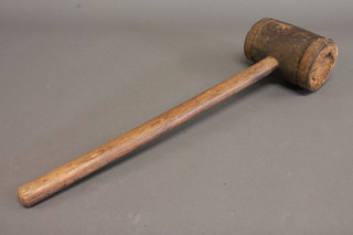 A large wooden and metal banded mallet