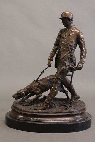 A bronze figure of a Continental huntsman and hound 16",  raised on an oval marble base,