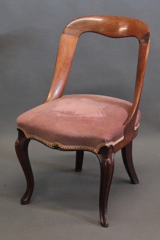 A Victorian mahogany spoon back chair with upholstered seat, raised on cabriole supports