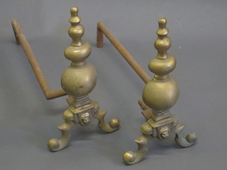 A pair of brass and iron Dutch style fire dogs