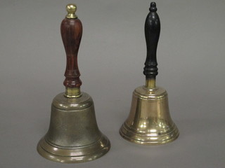 2 brass hand bells with turned wooden handles