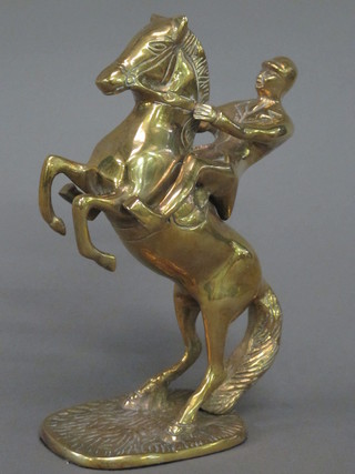 A brass figure of a rearing horse and rider 8"