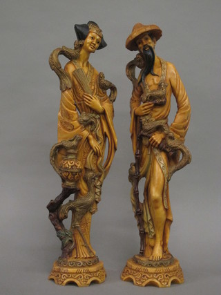A pair of resin figures of standing Oriental lady and gentleman 19"