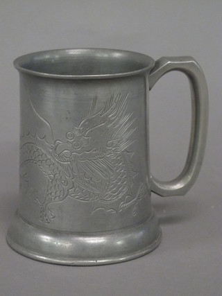 An Oriental pewter tankard decorated dragons, with glass bottom