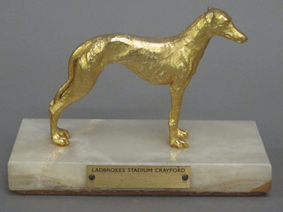 A gilt metal greyhound trophy in the form of a standing  greyhound, marked Ladbrokes Stadium Crayford 7"