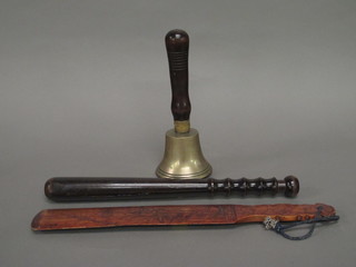 A brass hand bell with turned wooden handle, a carved Oriental newspaper opener and a turned wooden truncheon