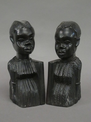 A pair of carved African hardwood bookends in the form of  portrait busts 9"