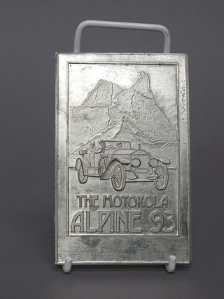 A cast metal rectangular double sided plaque marked Motorola Alpine 93 to commemorate the 80th Anniverary of an automobile run 22nd- 29th June 1913, 4 1/2" x 3"