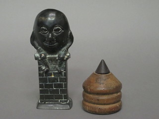A 19th Century cast metal money box in the form of Humpty  Dumpty 5 1/2" and a turned wooden spinning top