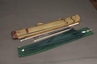 A fibre rod case containing a large umbrella and various rod rests